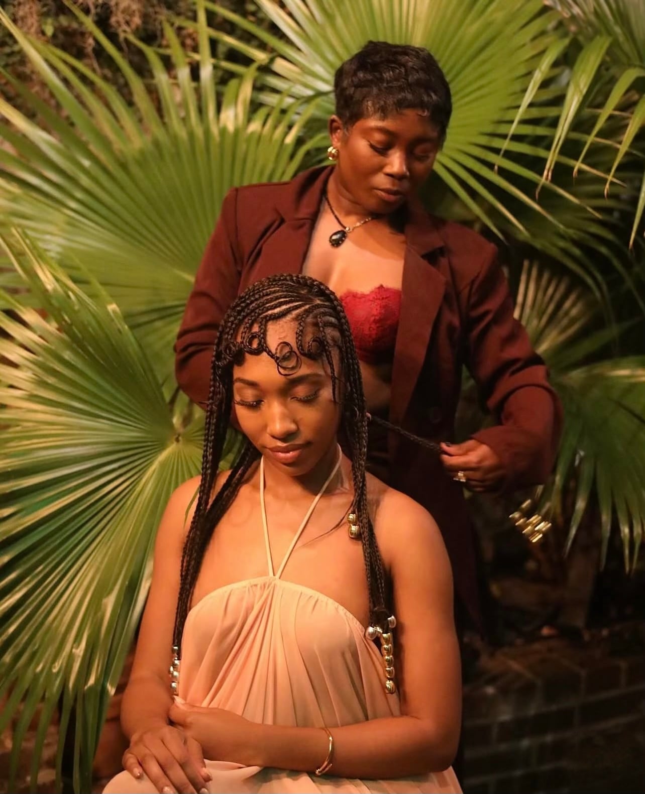 Live braiding at an event — stylist braiding a client on-site